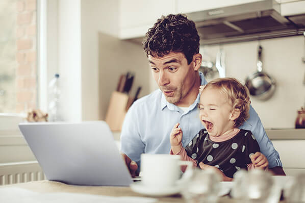 A father with his child using a laptop
