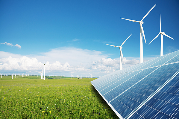 A field of solar panels and wind turbines