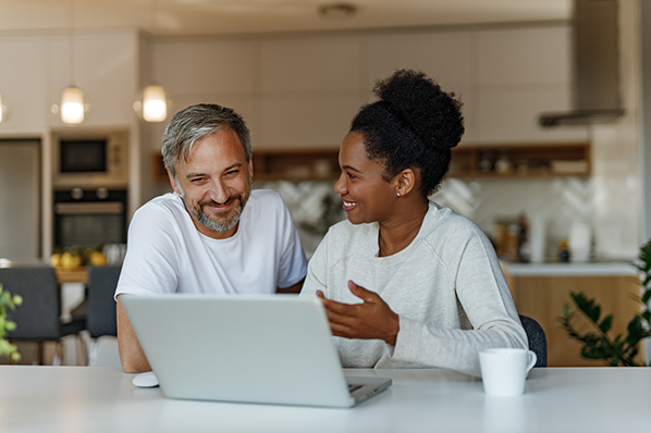 A man and a woman using a laptop