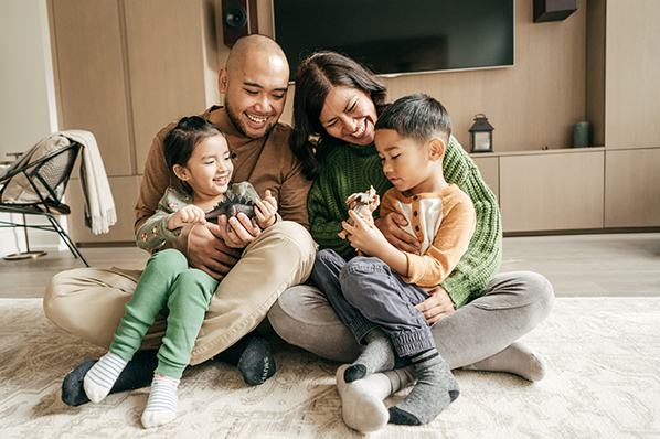 A family of four huddled on the living room floor