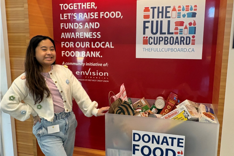A woman standing beside a donation bin