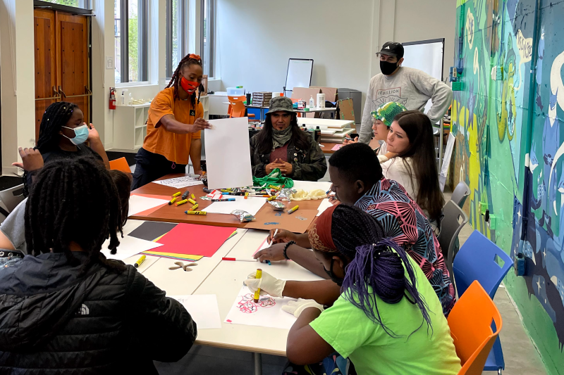 Children making art at a common table