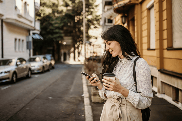 A woman on the street browsing her smartphone