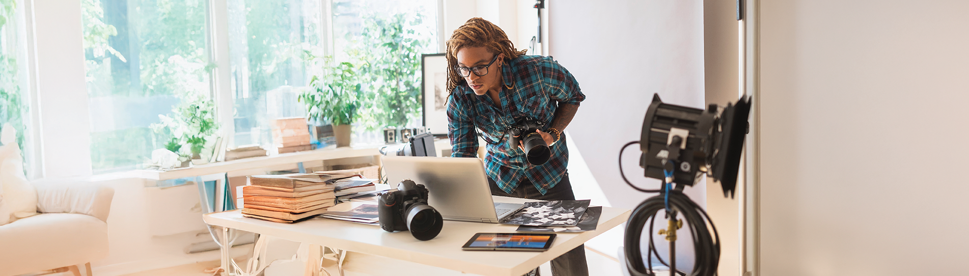 A photographer in a studio setting up to take a photo